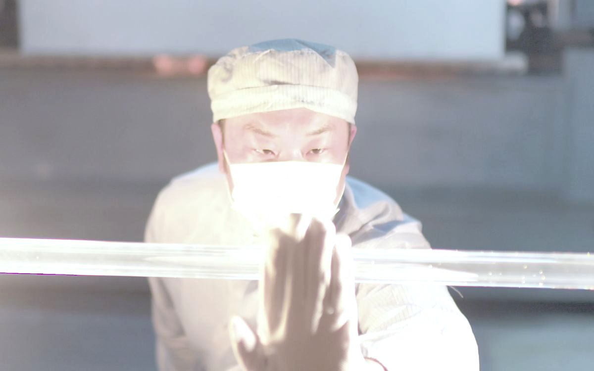 Engineer inspecting a glass fibre preform