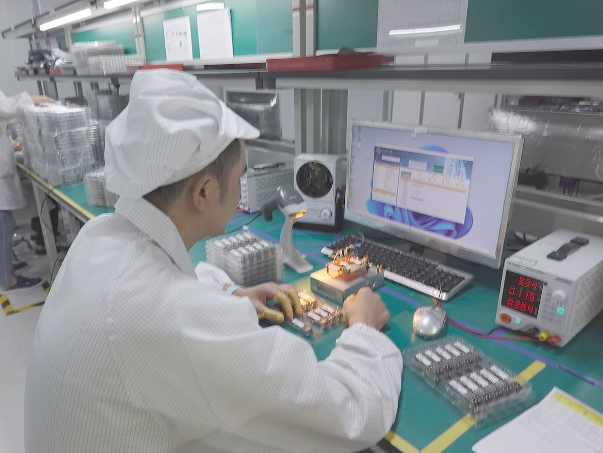 Engineer testing optical transceiver modules on an evaluation board